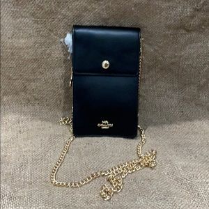 Brand new Coach black bag with tags. Minor dents